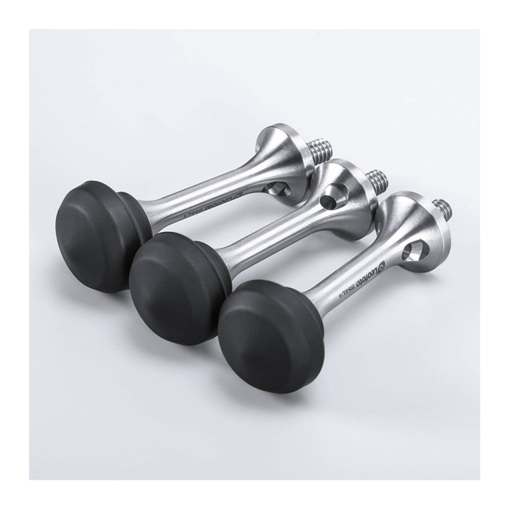 Three metallic tripod spikes with black rubber feet arranged in a row against a white background, showing the threaded mounting end and conical spike design from a three-quarter view.