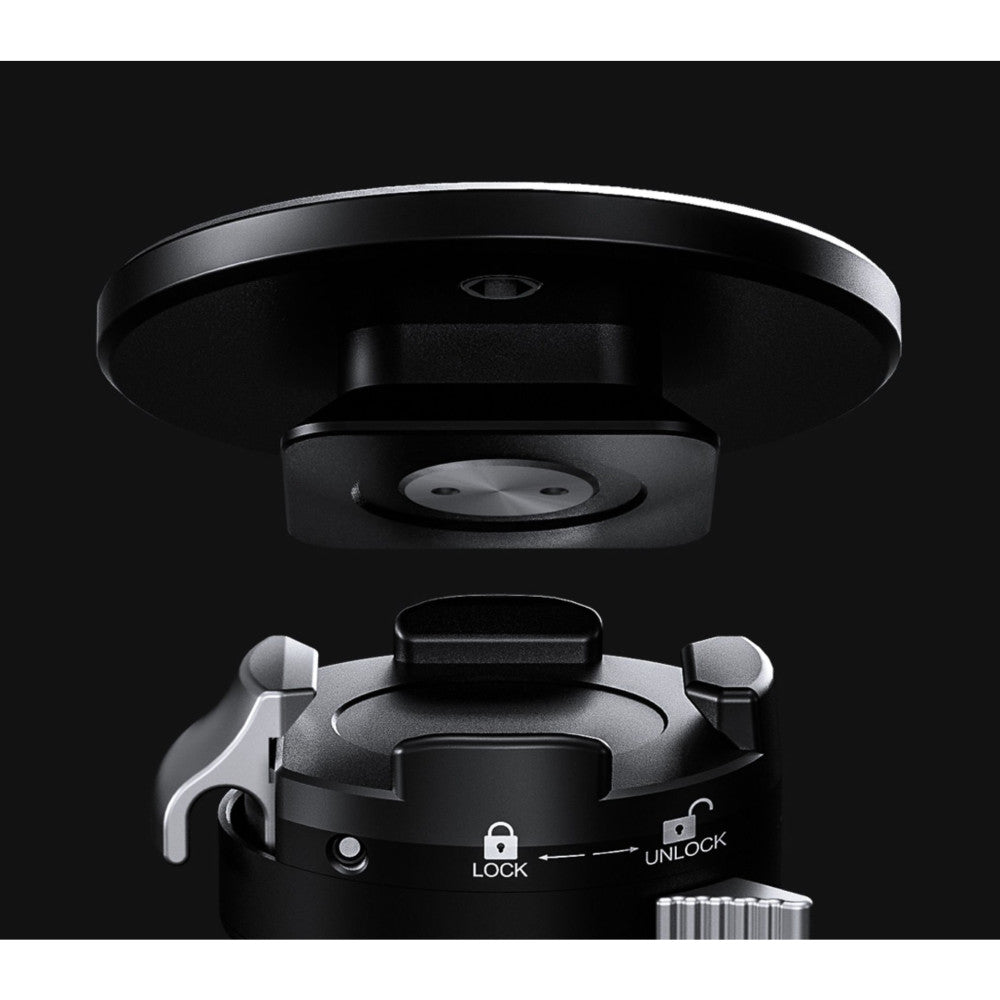 Overhead view of black monopod support stand showing circular base plate, central locking mechanism with lock/unlock positions, and quick release mounting system against dark background.