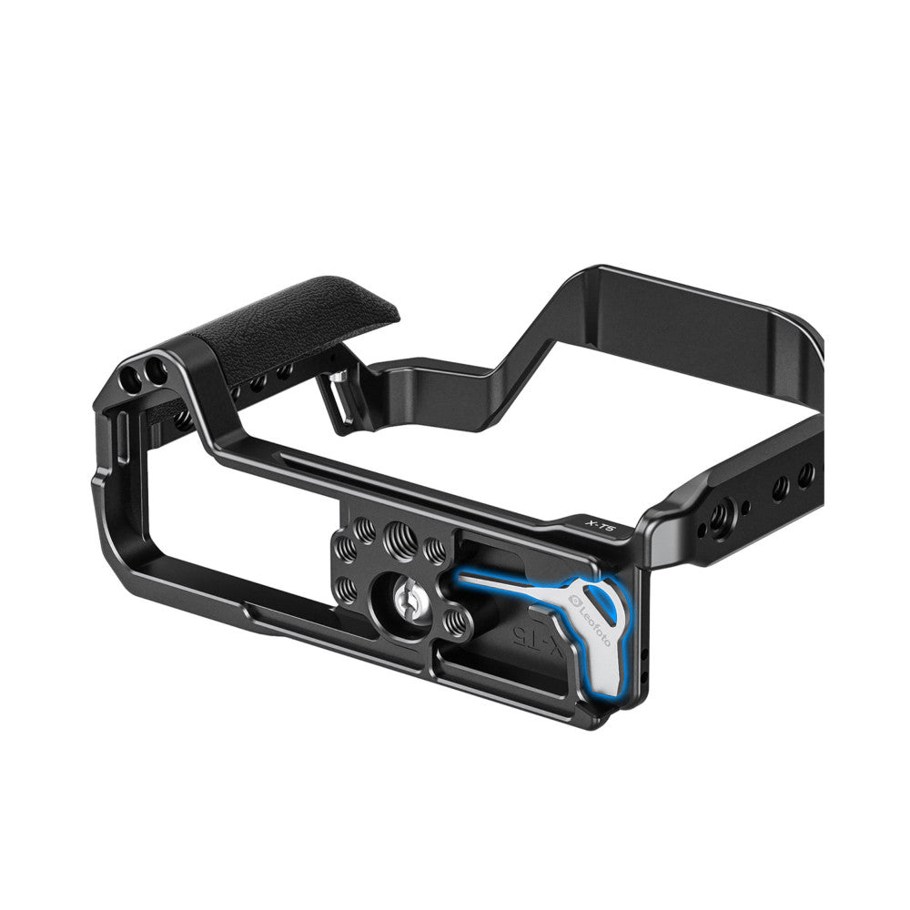 Black aluminum camera cage with textured grip handle, mounting plate with blue accents, and adjustment knobs, shown at three-quarter angle against white background.