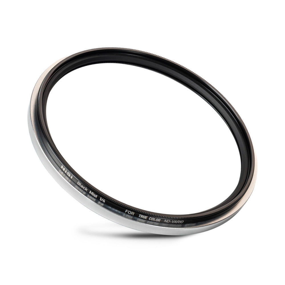 Angled view of a circular camera filter with silver and black metal ring showing the NiSi Black Mist 1/4 label against white background.
