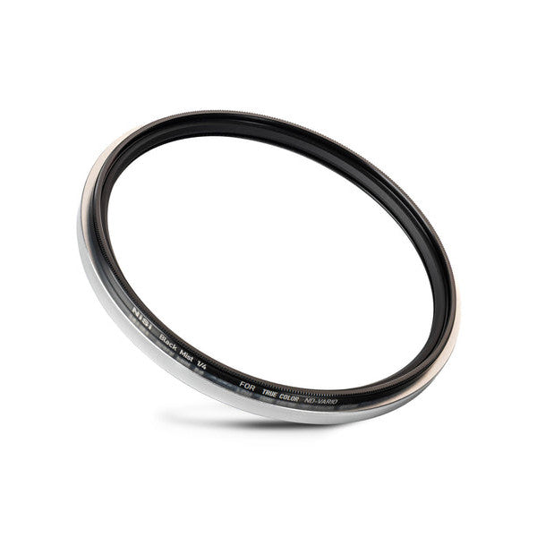 Angled overhead view of a circular camera filter ring with black glass and metallic silver-gray rim against white background.