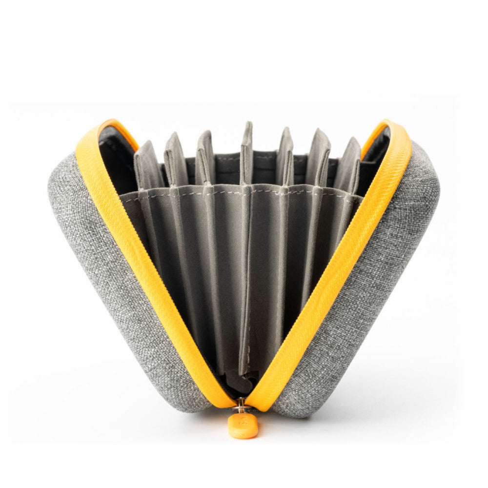 Open case displaying NiSi filter kit with gray and yellow fabric exterior, showing organized compartments holding multiple circular metal filters inside.