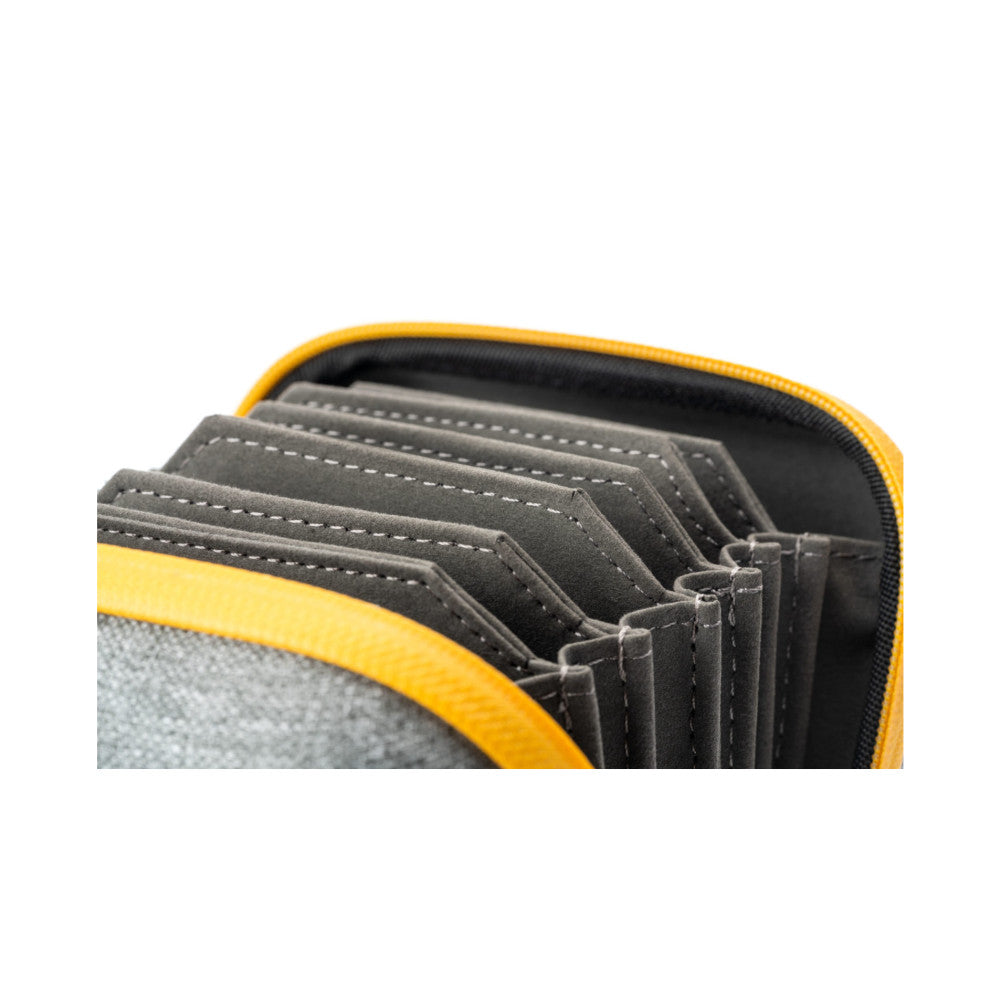 Close-up of open yellow camera filter case showing multiple stacked gray filter pouches with white stitching inside black-lined compartments.