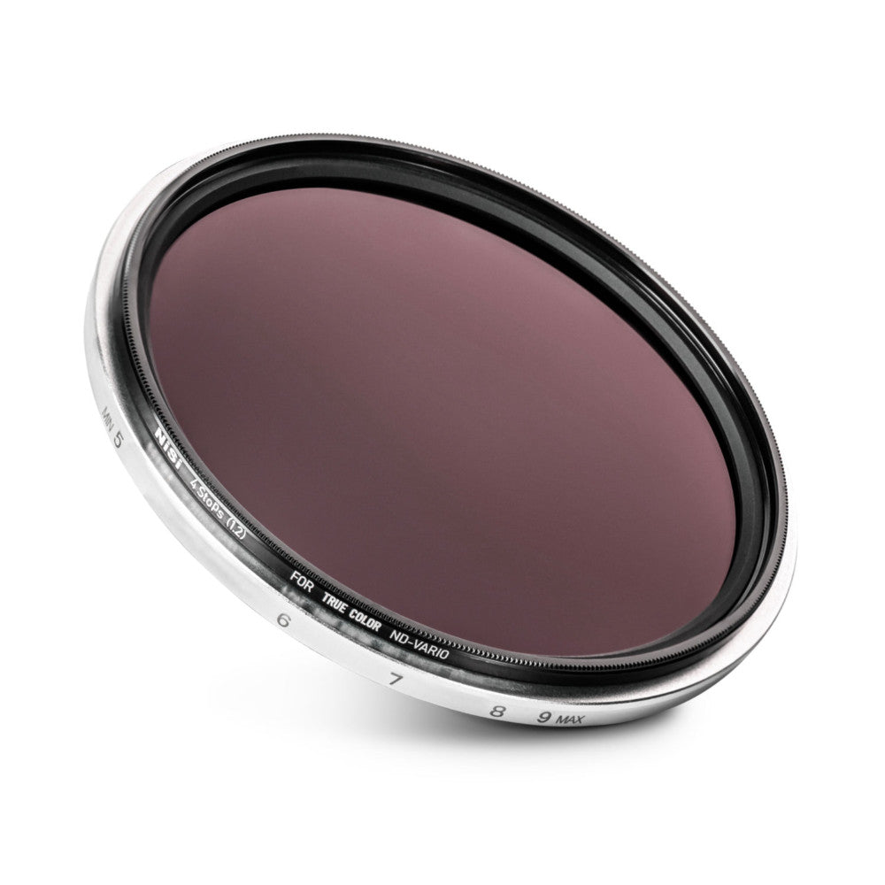 Angled view of a circular camera filter with dark tinted glass and labeled metal ring showing adjustment markings from 6 to 9 MAX.