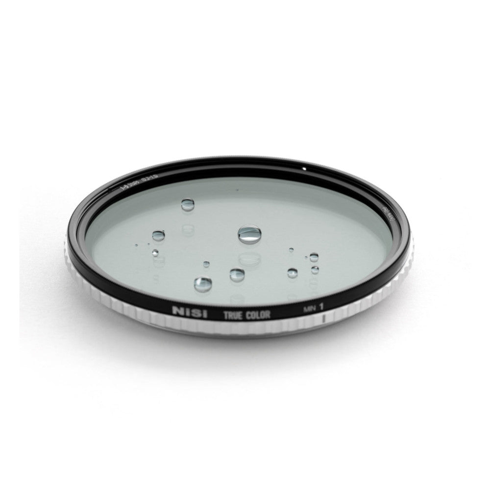 NiSi 67mm circular filter viewed from above at an angle, showing water droplets on the glass surface and black ring with white text labeling.