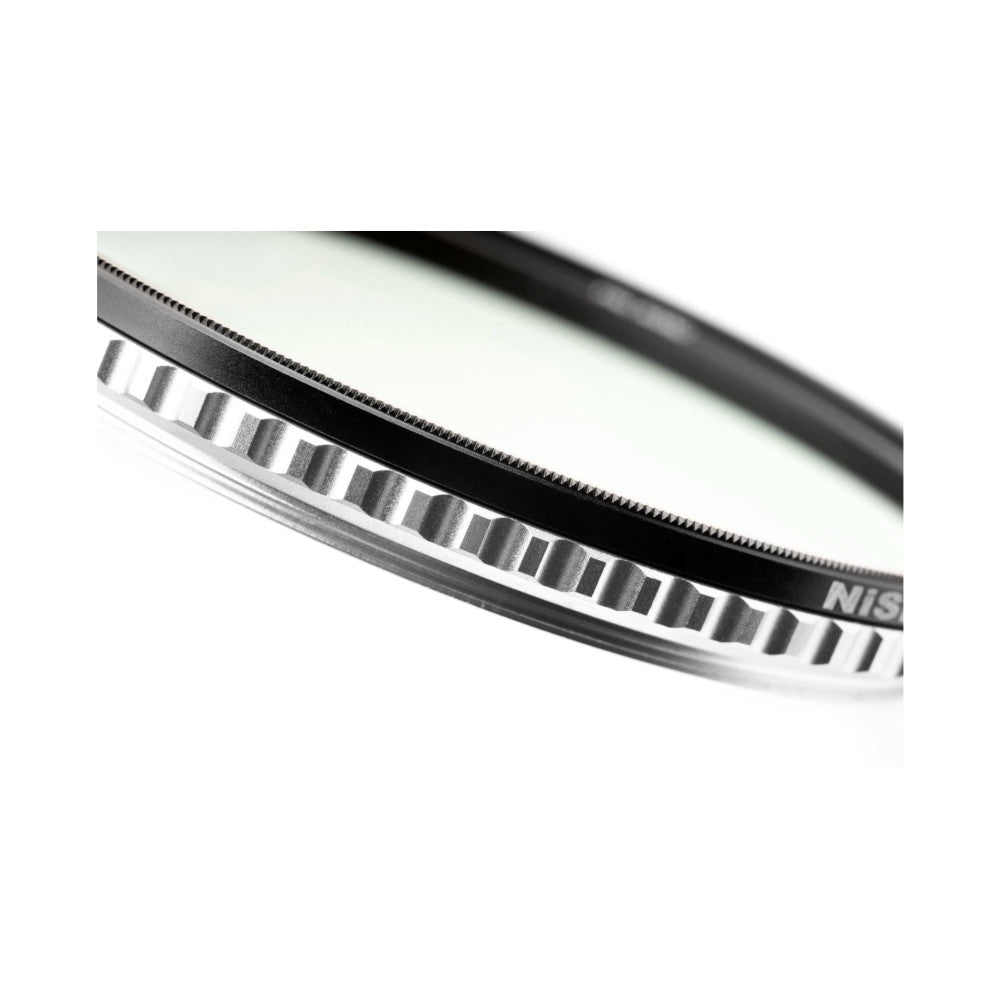 Close-up detail of NiSi SWIFT 82mm filter ring showing serrated edge and graduated density markings on white band.