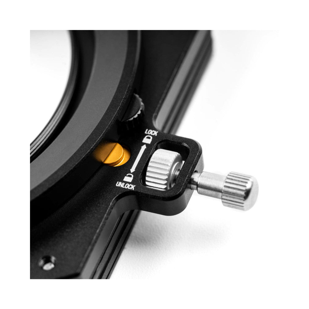 Close-up detail of NiSi M75-II filter holder showing lock/unlock mechanism and metal knob against blurred filter rings.