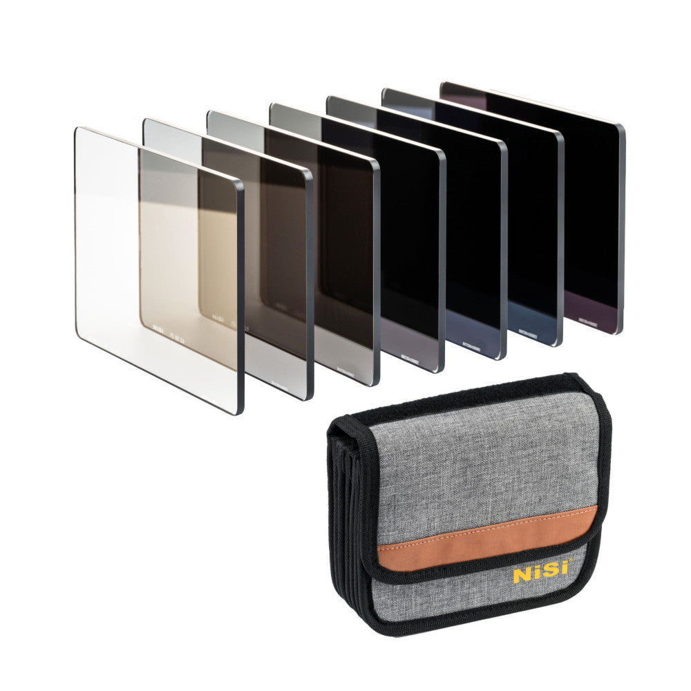 Nine rectangular ND filters in graduated gray tones displayed in a fan arrangement, with a gray and tan NiSi carrying case below.