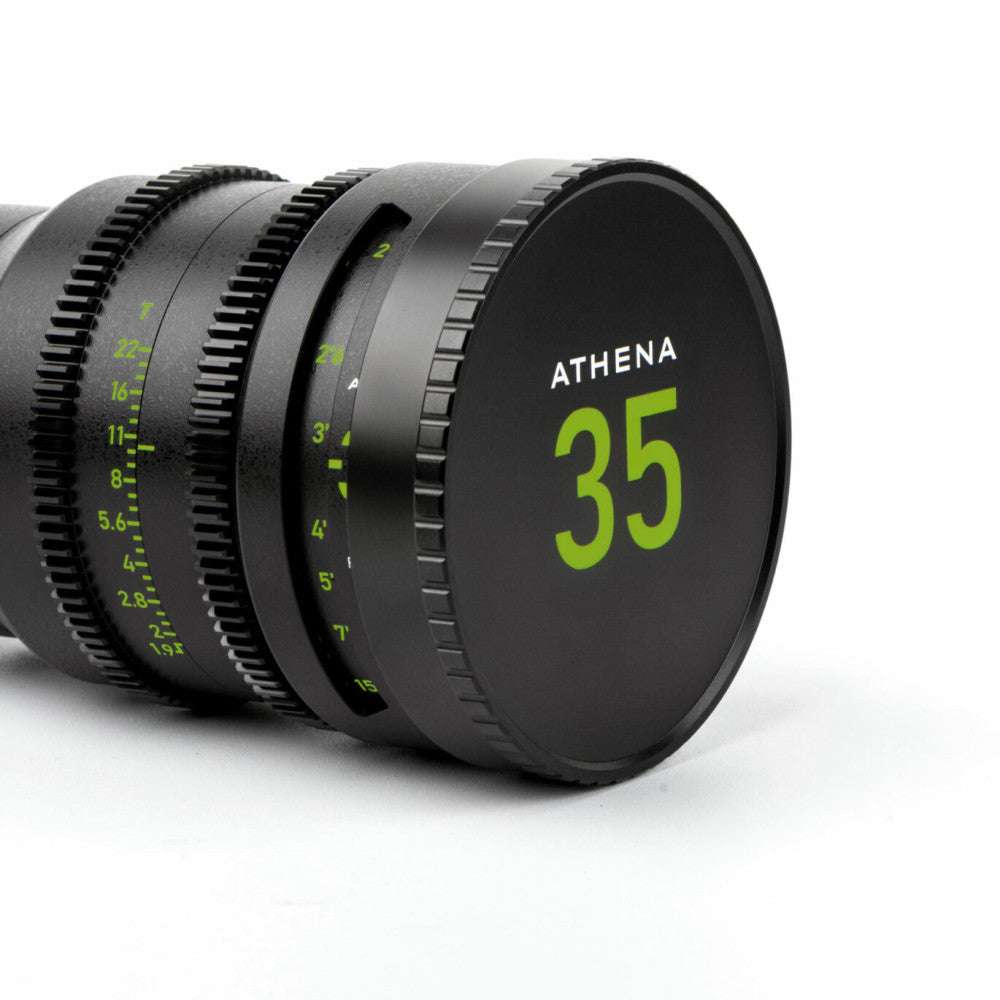 Close-up side view of black NiSi Athena 35mm cinema lens cap with lime green markings and focal length numbers visible on the barrel.