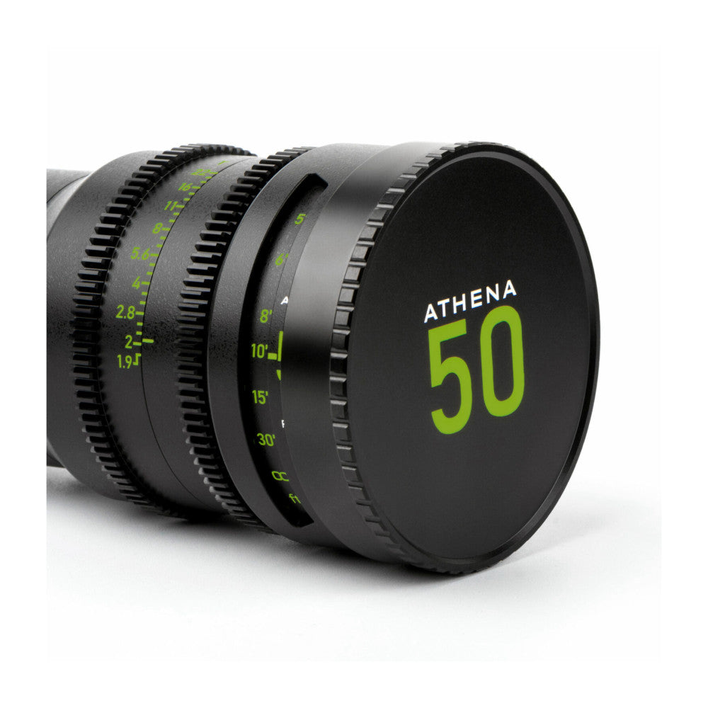 Close-up side view of NiSi ATHENA 50mm cinema lens showing focus ring markings and black lens cap with green branding.
