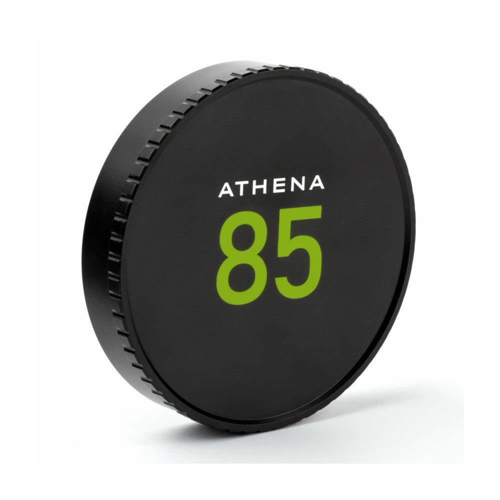 Black circular lens cap for NiSi ATHENA 85mm cinema lens, shown at an angle displaying the front face with green "85" branding and threaded rear edge.
