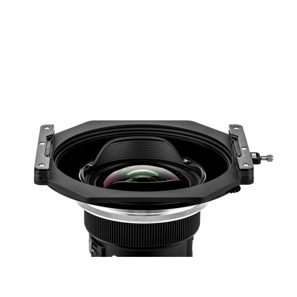 Top-down view of a black square filter holder with attached lens mount and colorful glass optical elements visible inside.