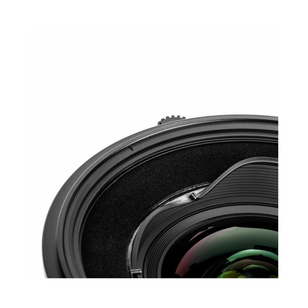 Close-up detail of camera lens filter holder showing threaded metal ring, black fabric interior, and lens glass elements.
