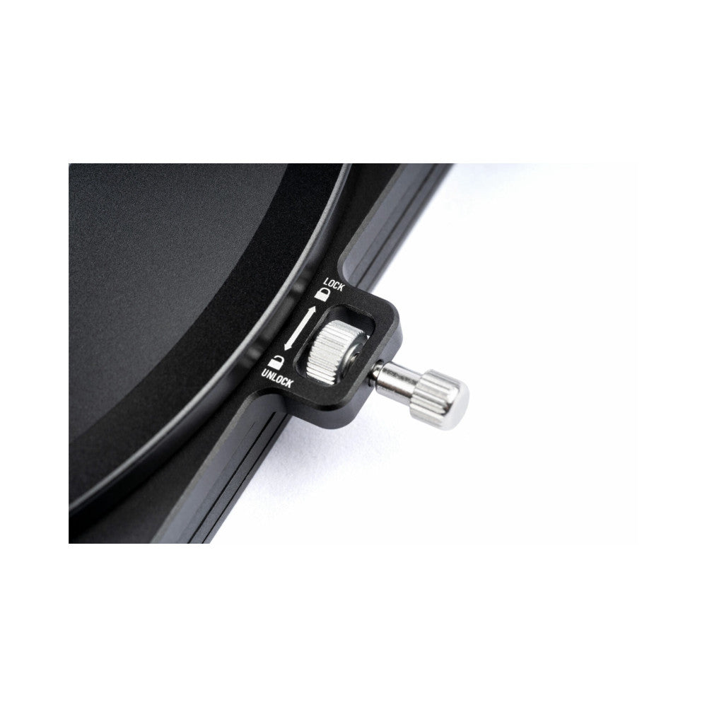Close-up of a black filter holder's lock mechanism showing "LOCK" and "UNLOCK" positions with a metal knob and ribbed adjustment dial.