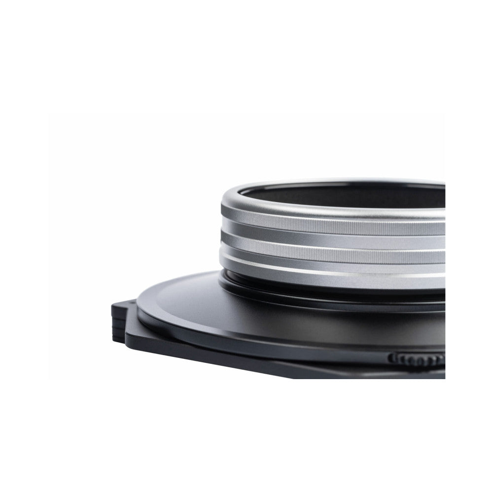 Close-up of stacked camera filter holder rings showing metal bands and black base plate against white background.