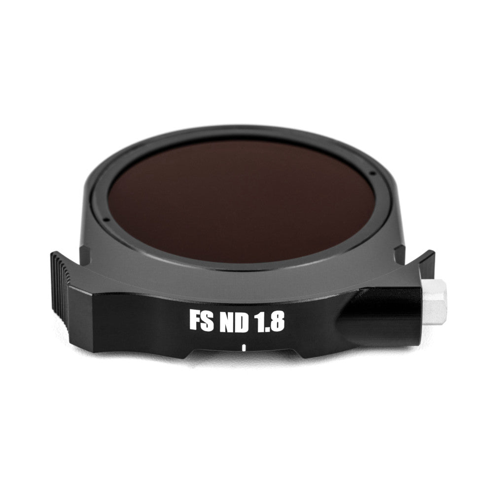 Dark gray circular ND filter with "FS ND 1.8" label visible on black mounting bracket, shown from top angled view against white background.