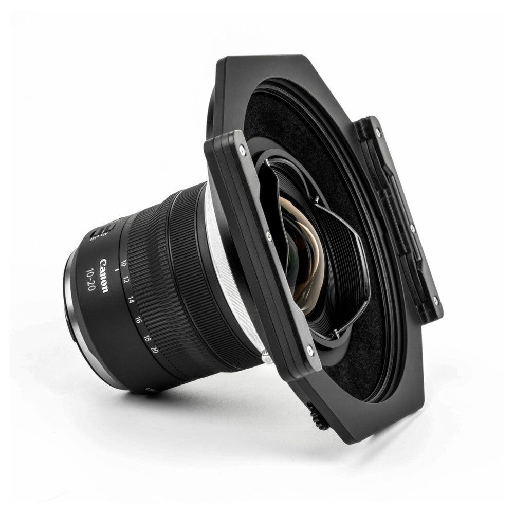 Canon RF 10-20mm lens mounted with NiSi S6 ALPHA 150mm filter holder, angled side view against white background.