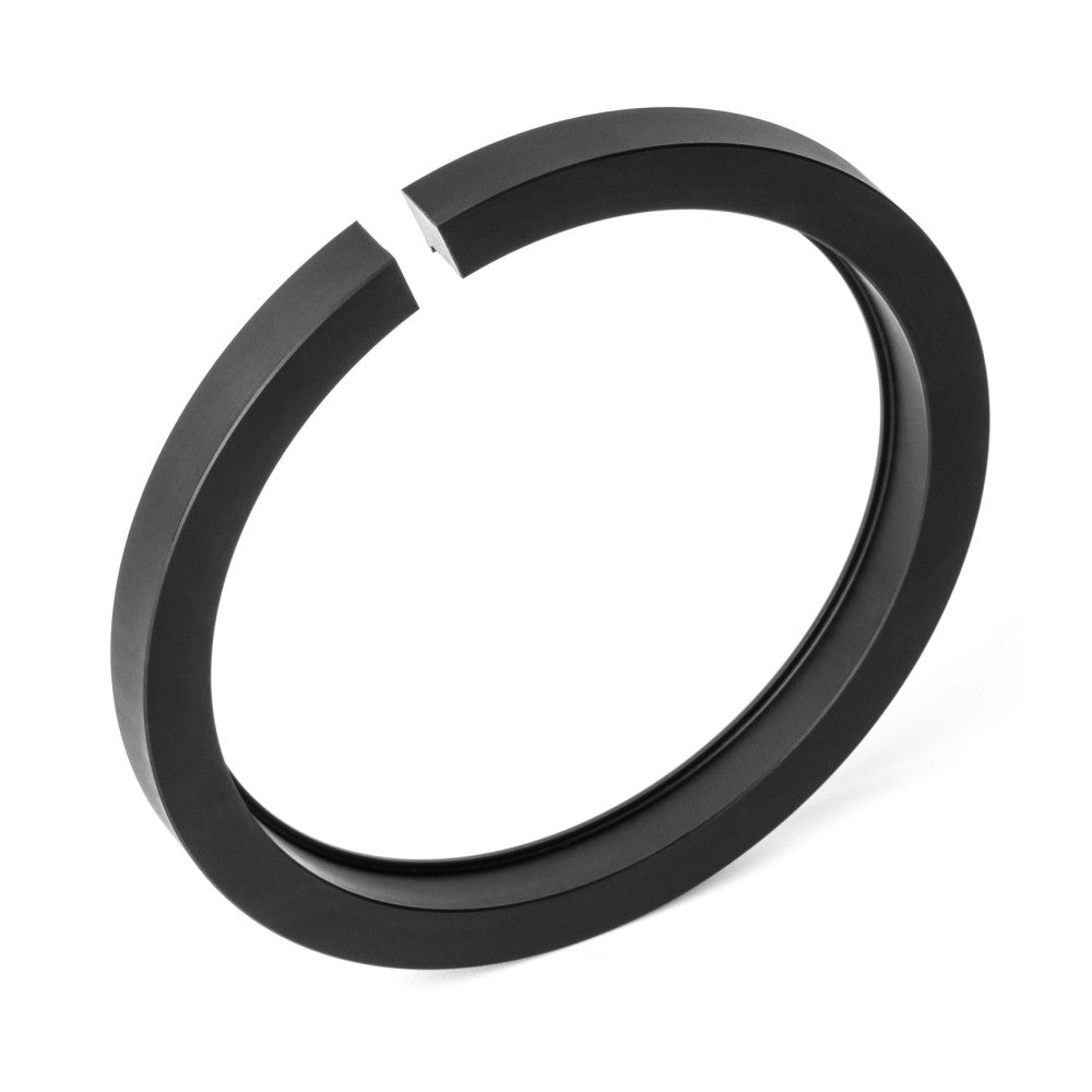 Black circular metal adapter ring shown from angled perspective against white background, displaying open gap at top and layered cylindrical design.