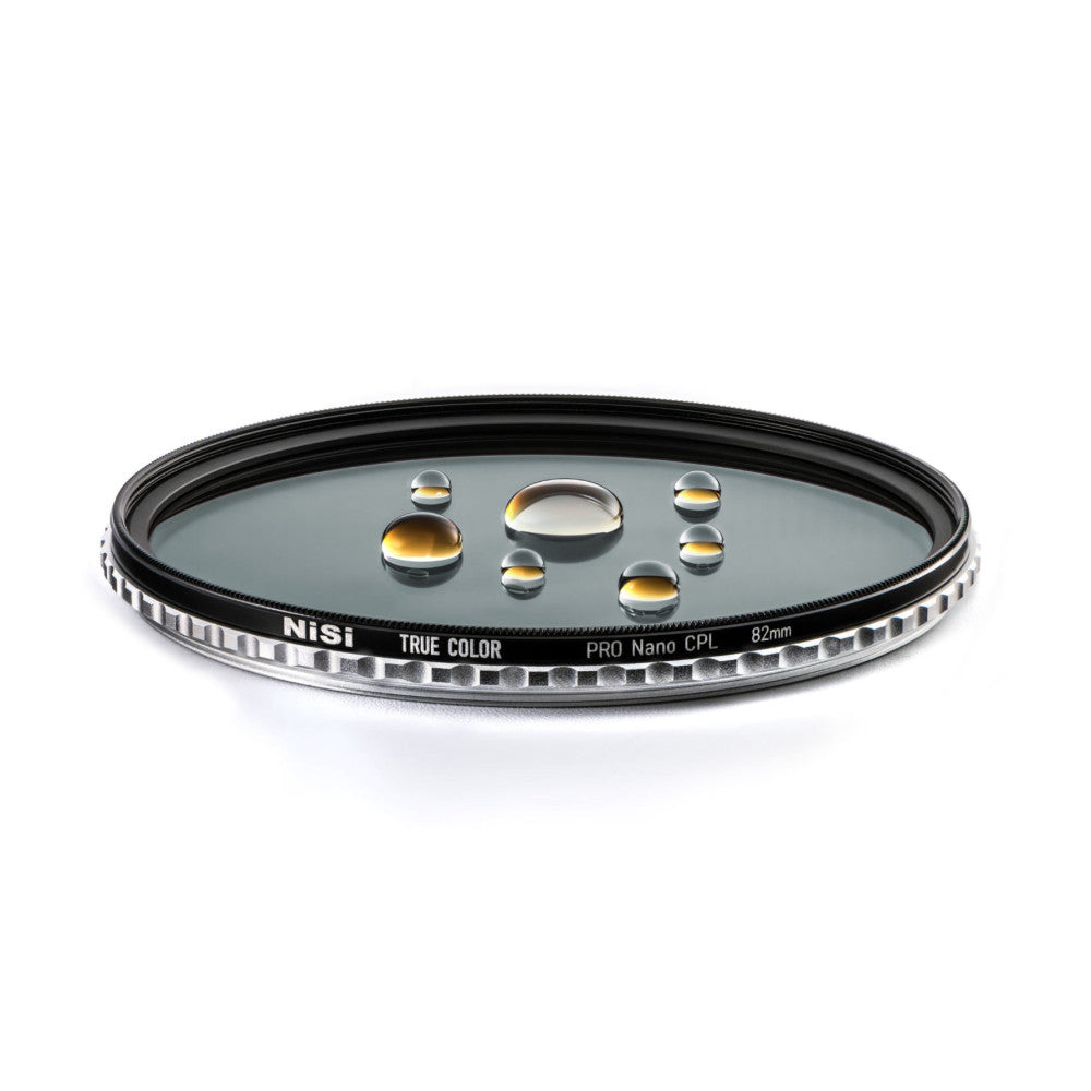 NiSi PRO Nano CPL 82mm circular polarizing filter shown at an angle displaying water droplets on its glass surface against a white background.