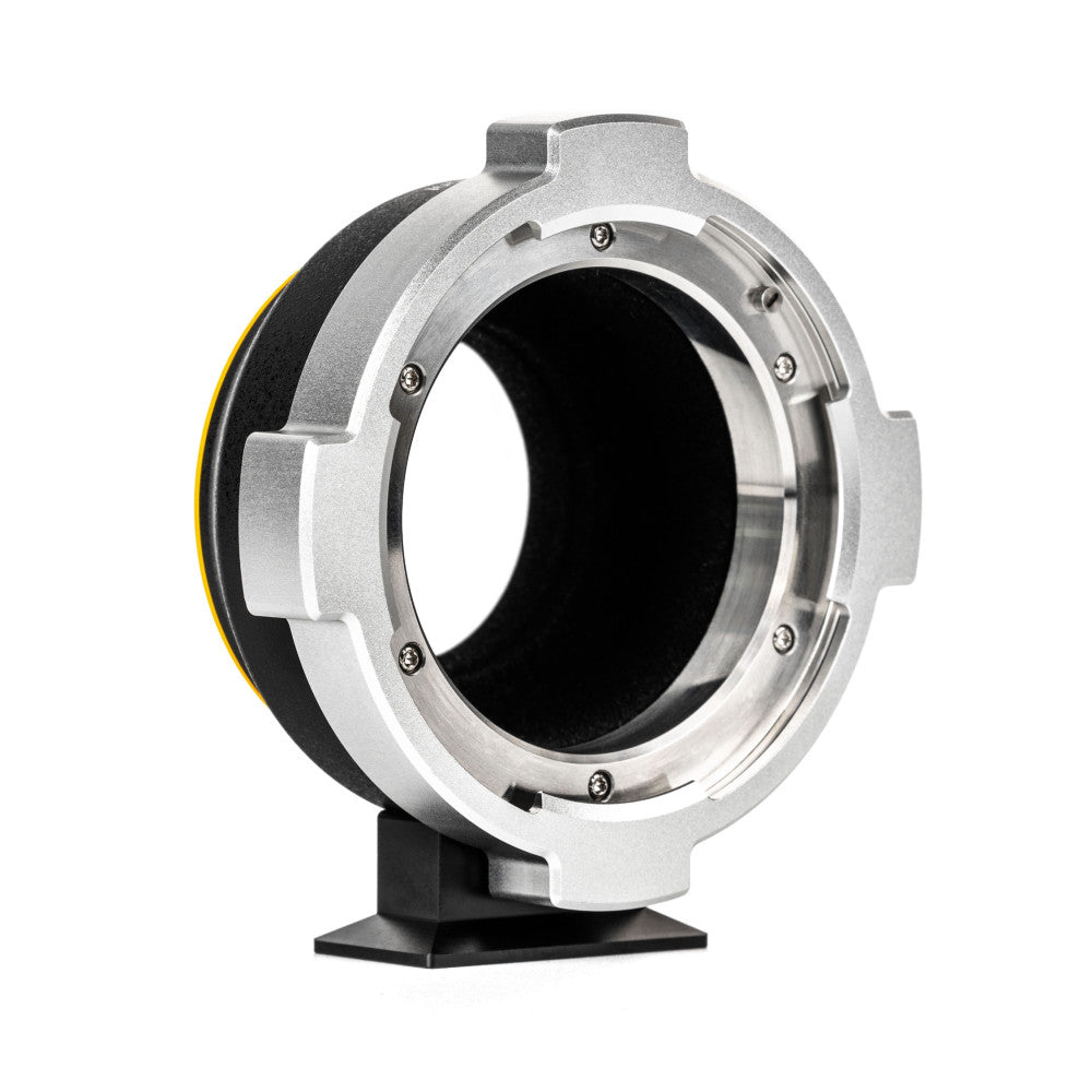 Side view of a silver and black lens mount adapter showing the circular opening and mechanical components with visible screws.