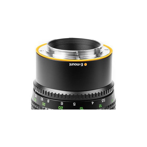 Close-up front view of a black telephoto lens with yellow E-mount ring and green aperture scale markings visible on the barrel.