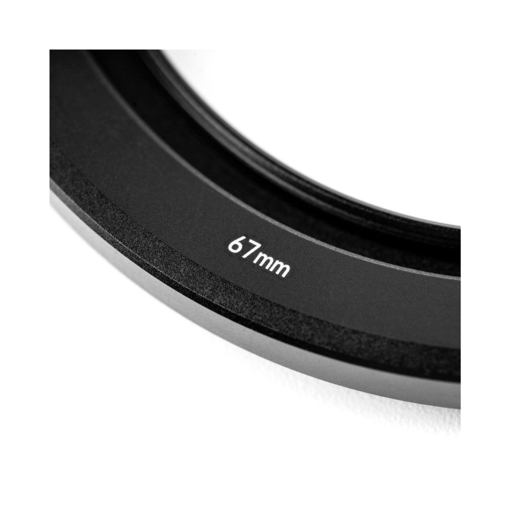 Close-up detail of 67mm filter ring showing size marking on black circular camera lens filter against white background