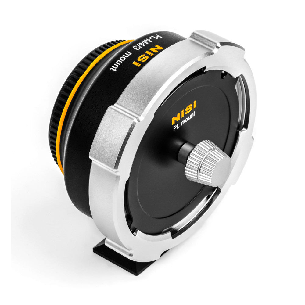 NiSi PL-M4/3 lens adapter shown at an angle, displaying white metal body with black and yellow accent bands and adjustment knob.