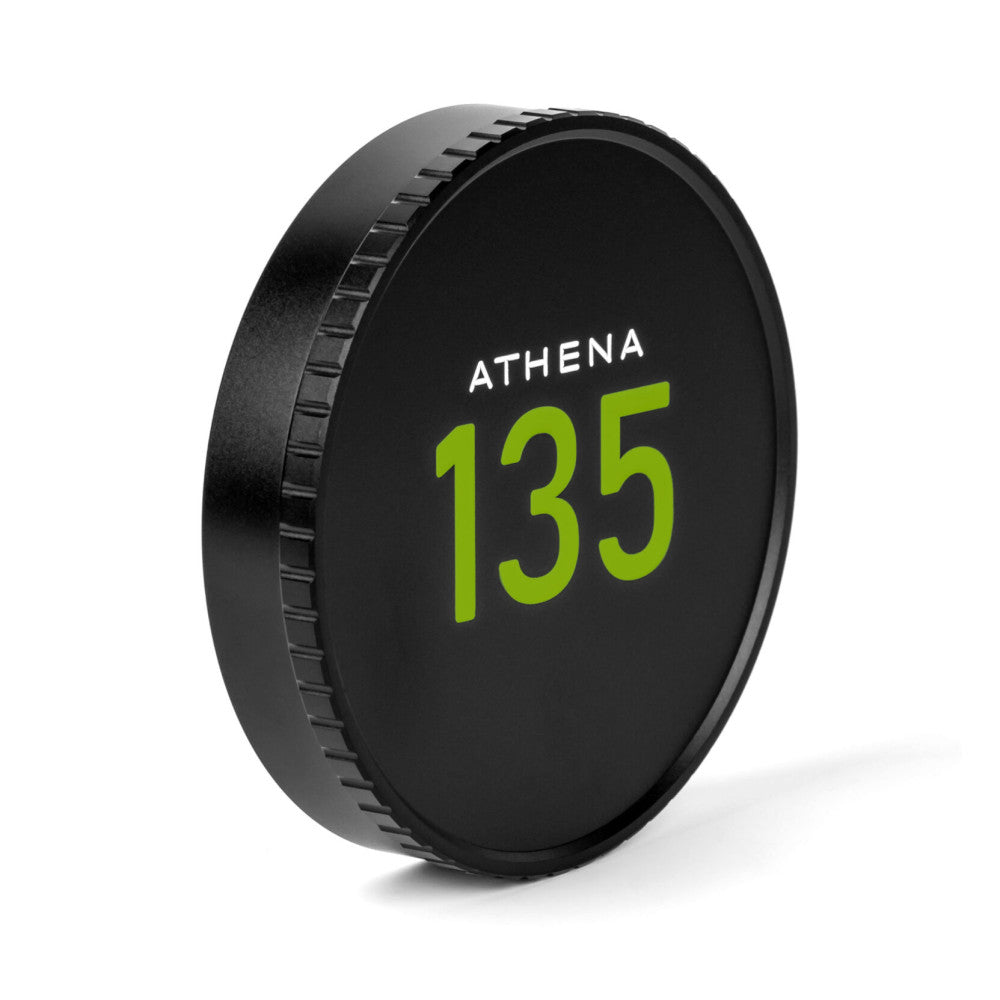 Black lens cap with "ATHENA 135" in green text, shown at a 3/4 angle displaying the threaded grip ring on its side.