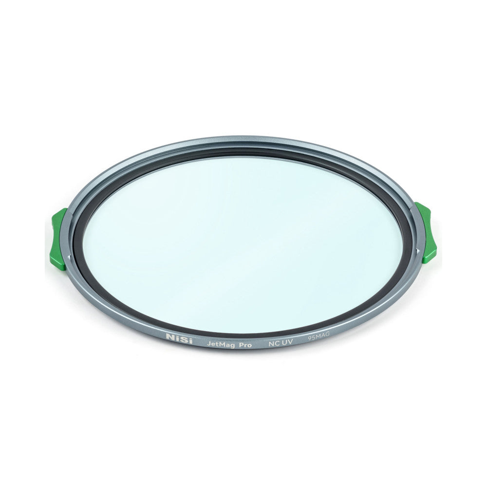 Overhead angled view of a circular gray filter with green magnetic handles and light blue glass center, showing the NiSi JetMag Pro NC UV branding on the rim.