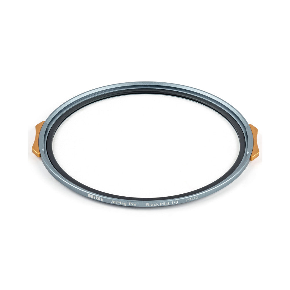 NiSi JetMag Pro Black Mist 1/8 filter ring viewed at an angle, showing the gray metal frame with copper magnetic tabs on the sides and text marking on the edge.