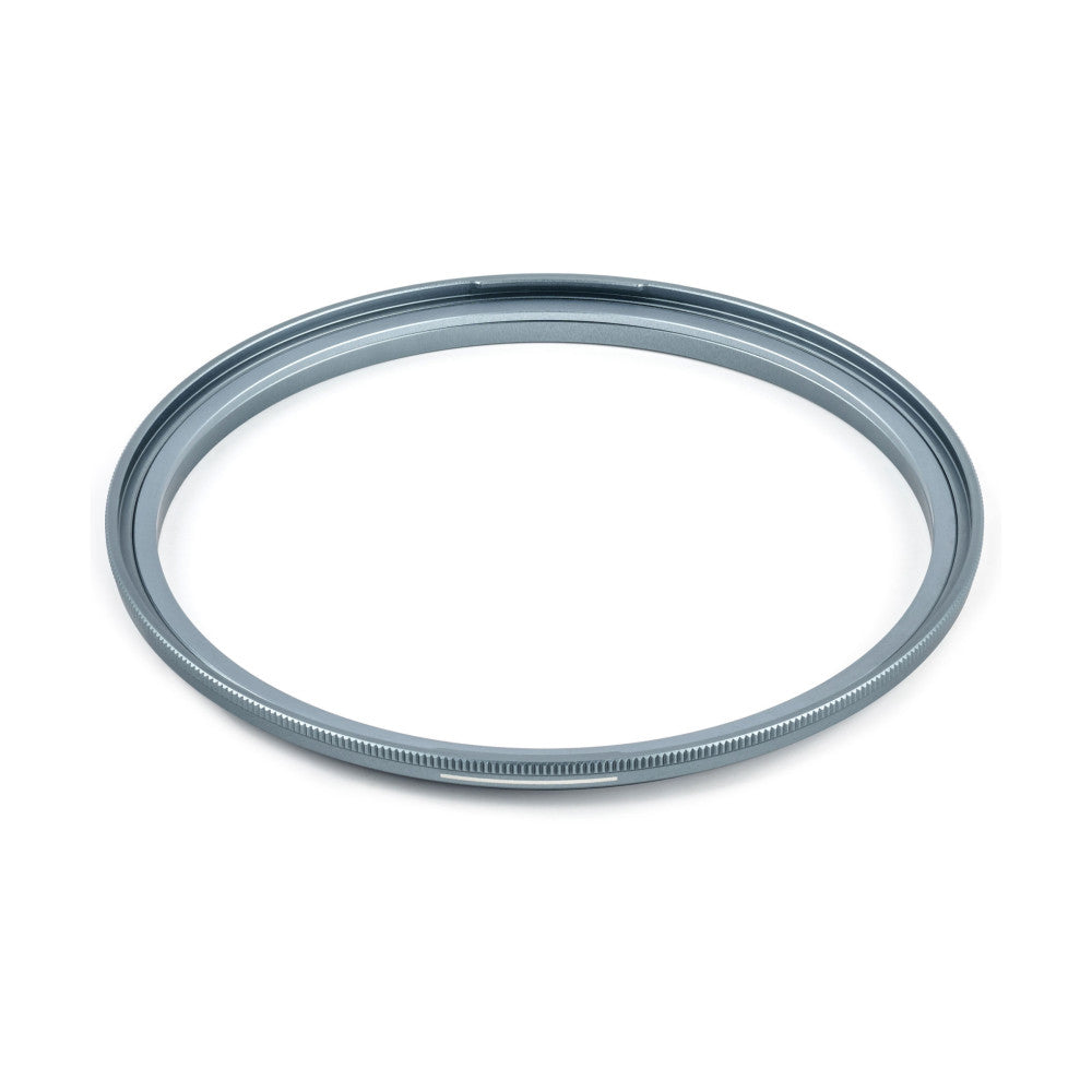 Gray metallic magnetic adapter ring shown at an angle against a white background, displaying the threaded inner surface and grooved outer edge.