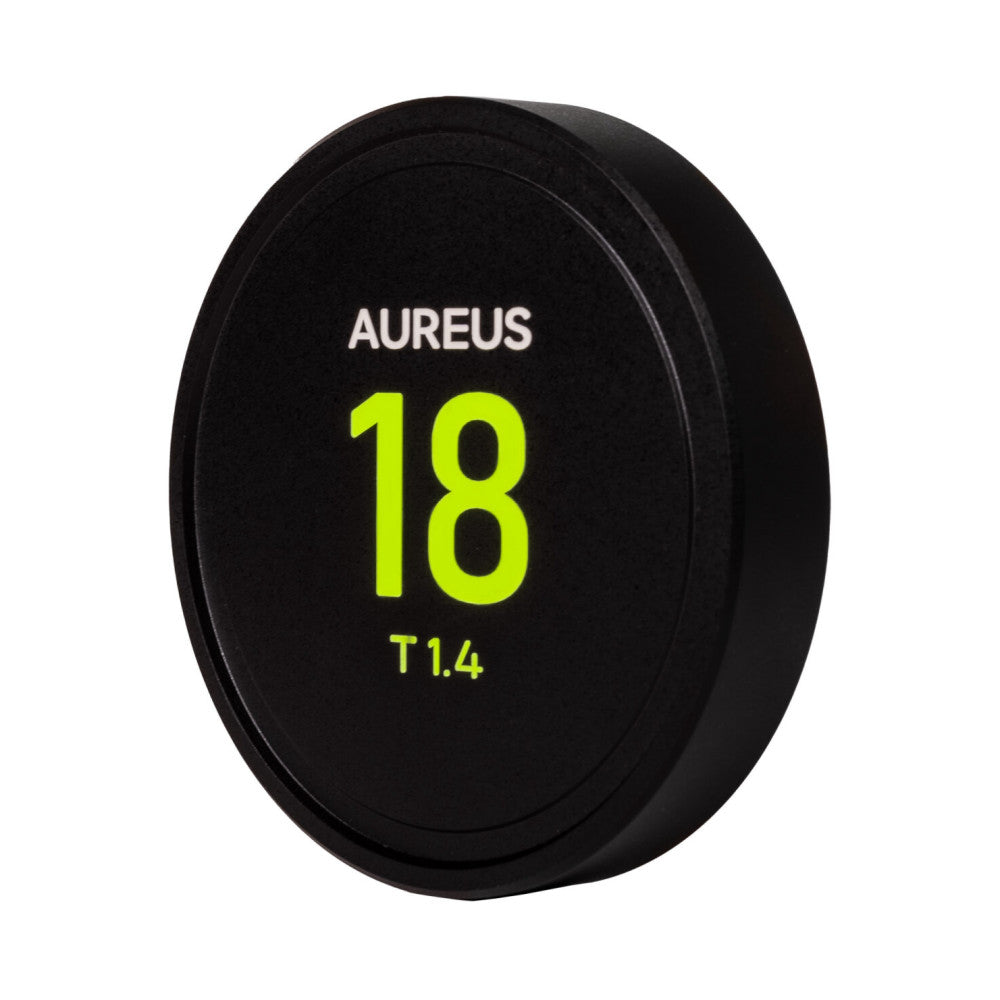 Black lens cap with white and neon yellow text reading "AUREUS 18 T1.4" against a white background, angled front view.
