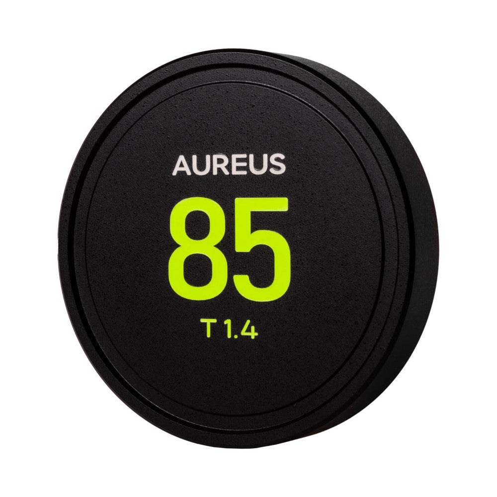Front view of a black circular lens cap displaying "AUREUS 85 T1.4" in bright yellow text on its surface.