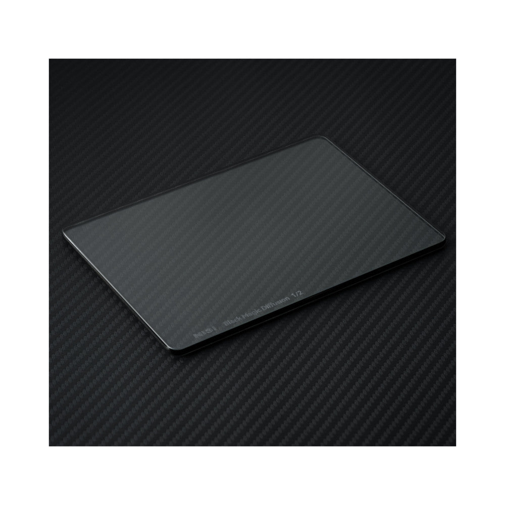 Rectangular glass filter on carbon fiber surface, angled view showing product text and rounded edges