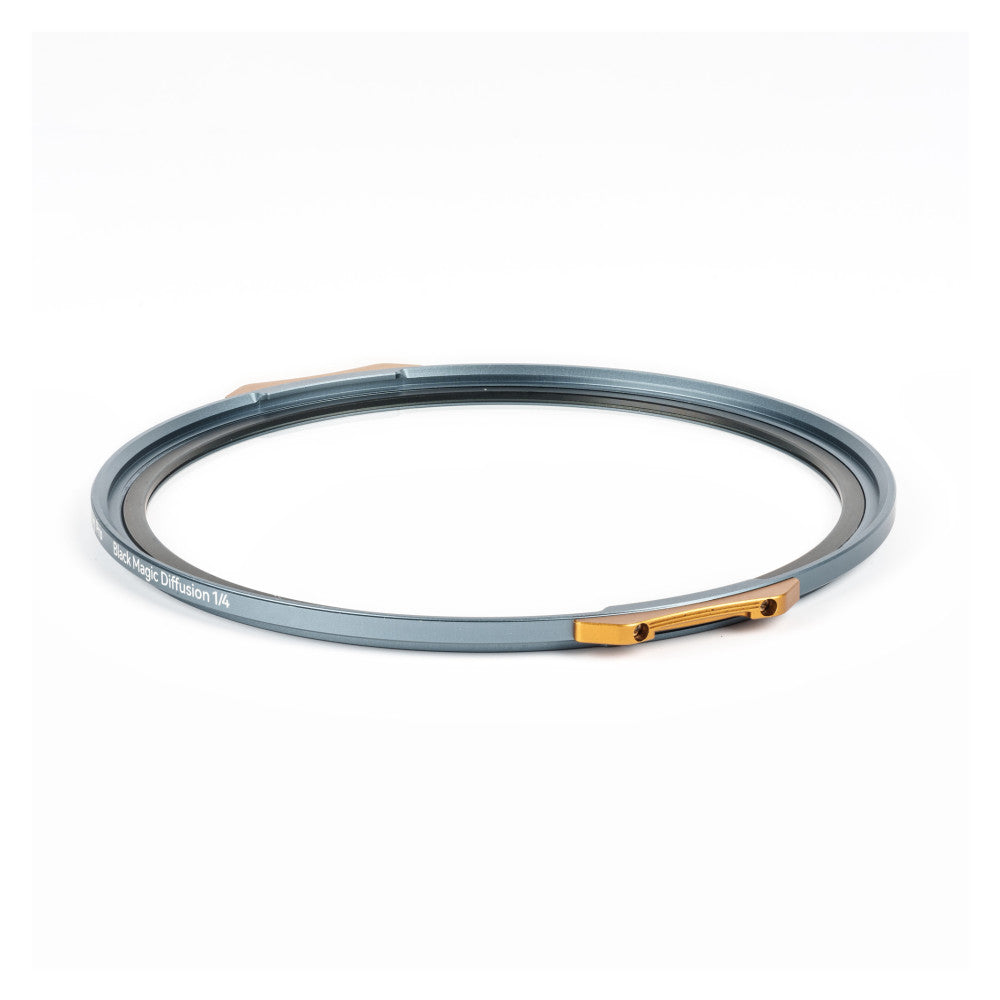 Circular gray magnetic filter ring with gold metal clasp, displayed at an angle against white background, showing text "NiSi JetMag Diffusion 1/4" on the rim.
