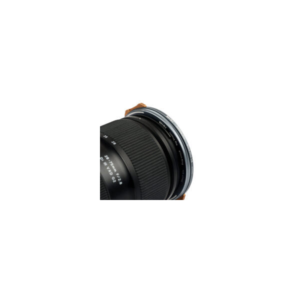 Close-up side view of NiSi JetMag Pro magnetic filter attached to camera lens with brown leather strap visible at top.