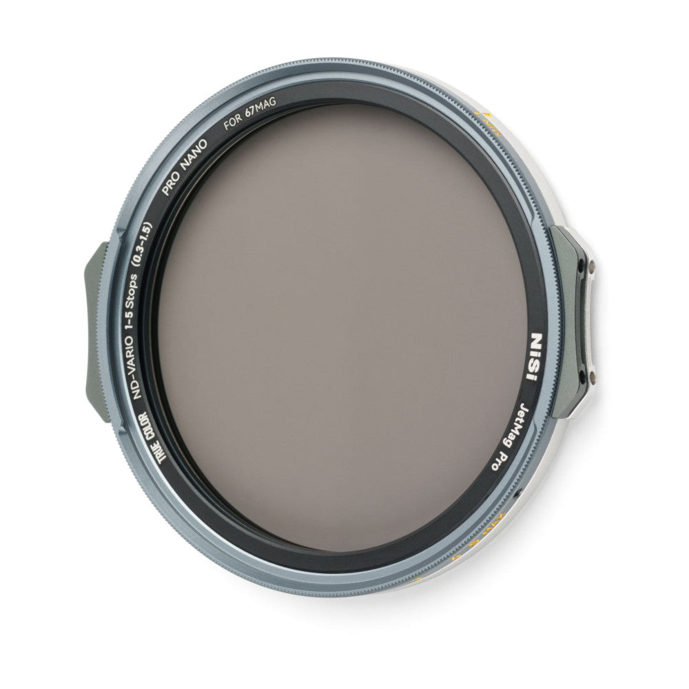 Front view of a circular ND filter with gray-tinted glass, mounted in a silver metal ring with black inner markings and adjustment tabs on either side.
