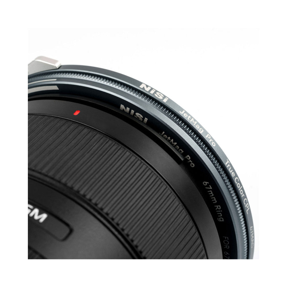 Close-up angled view of NiSi JetMag Pro magnetic adapter ring showing branded text, 67mm specifications, and black ribbed lens barrel detail.