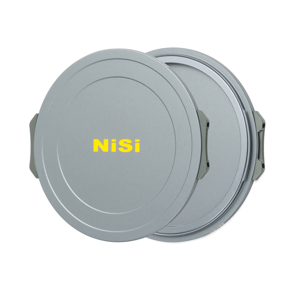Two gray circular magnetic lens caps shown from above at an angle, displaying both the front cap with NiSi branding and the back cap with visible magnetic ring detail.