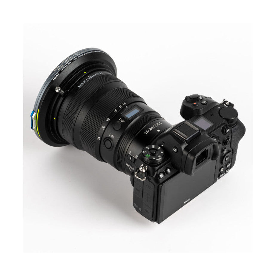 Overhead view of mirrorless camera with large telephoto lens and magnetic filter ring attachment mounted on top.