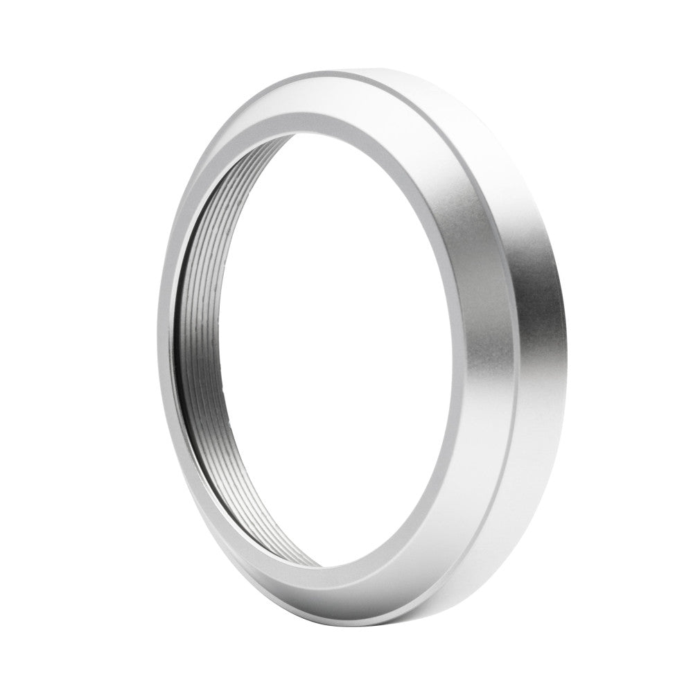 Angled side view of a metallic threaded filter ring with ribbed interior texture, photographed against white background.