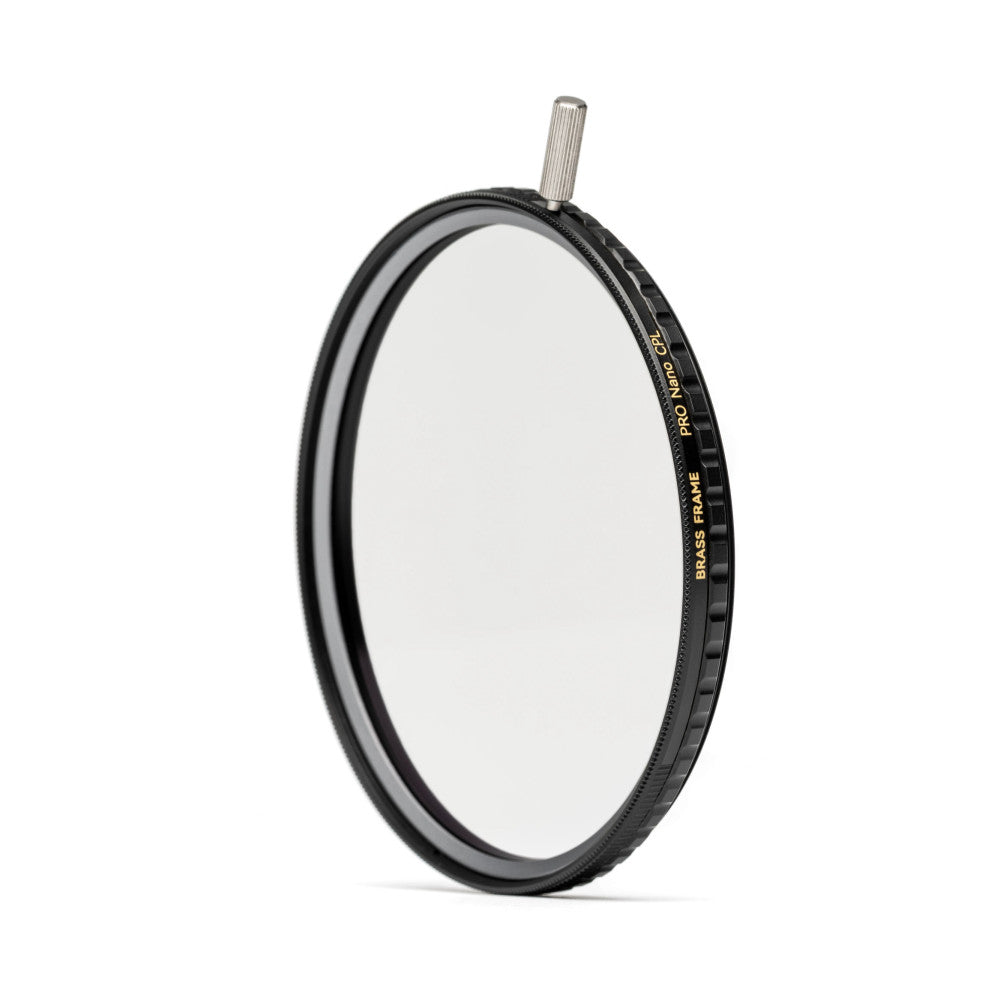 Side view of a circular polarizing filter with black brass frame and adjustment ring, showing the glass lens and product labeling on the dark rim.