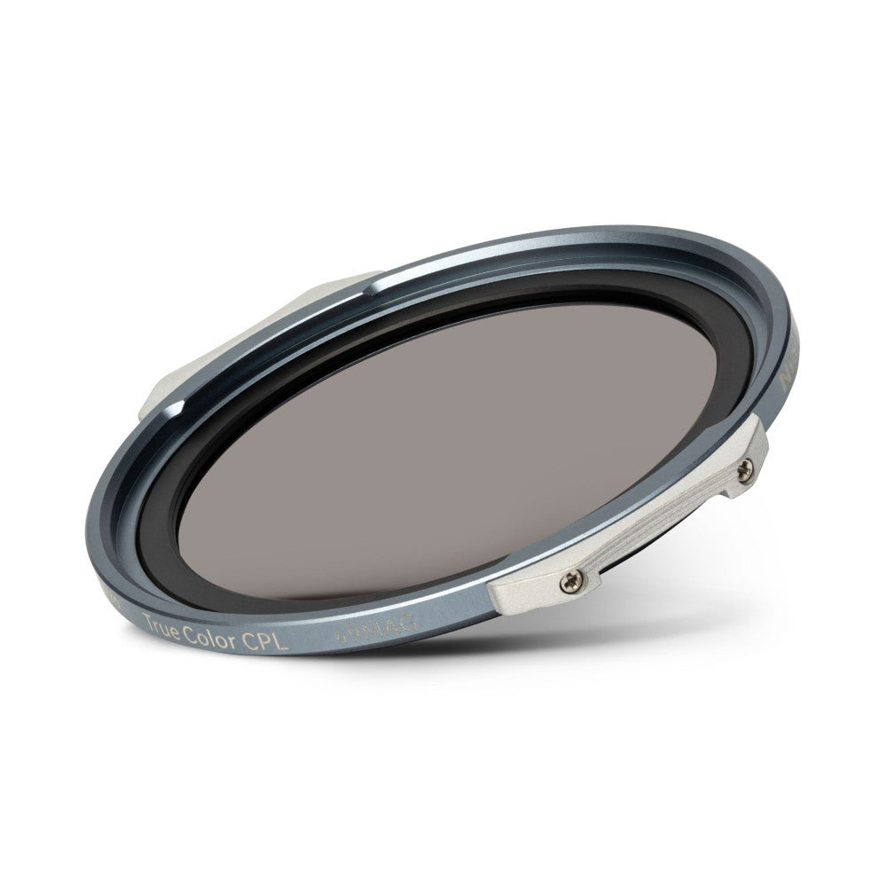 Angled view of a circular polarizing filter with gray metal frame and magnetic attachment, showing the dark tinted glass element and mounting hardware against a white background.