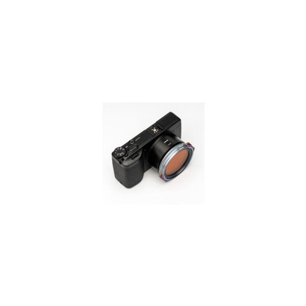 Black compact camera with attached magnetic red-tinted filter system, shown from side angle against white background