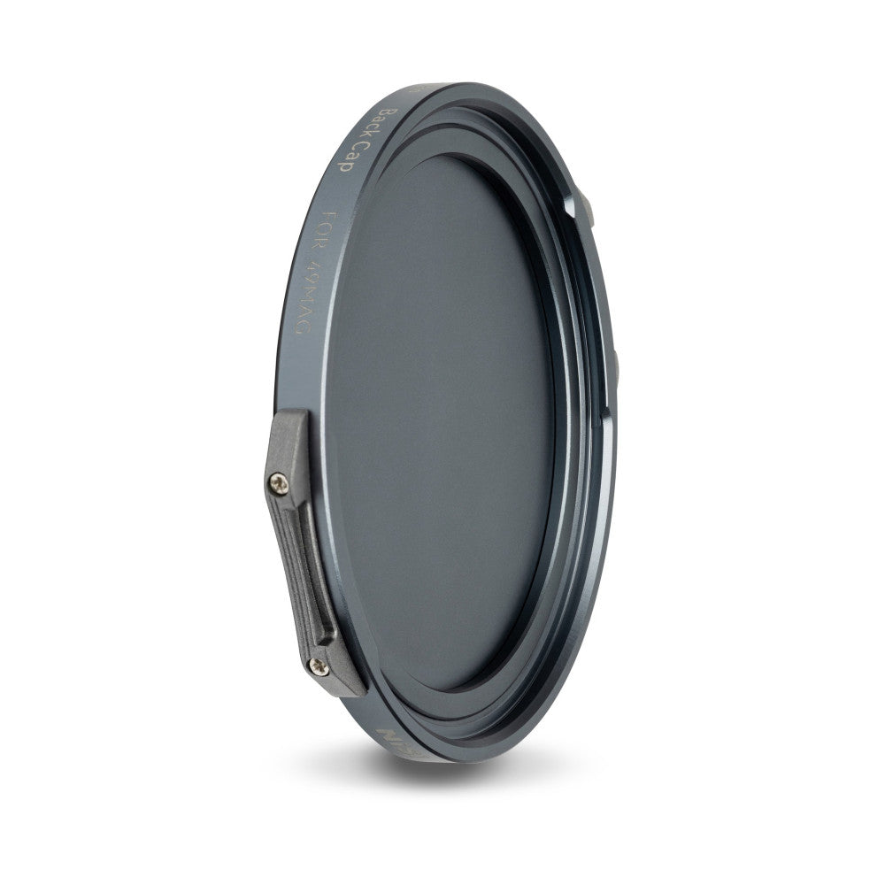 Dark circular magnetic filter cap shown at an angle, displaying the front surface and side profile with metal attachment points visible against a white background.