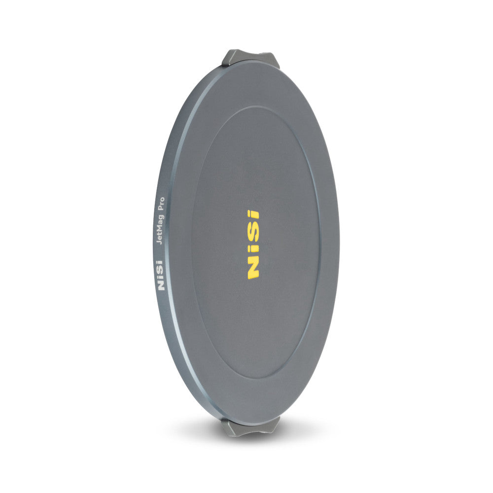 NiSi JetMag Pro magnetic front lens cap displayed at an angle, showing the gray circular cap with yellow branding and attachment mechanism.