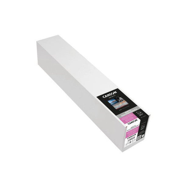 Angled side view of a white Canson Infinity Baryta Photographique II paper roll with black product label showing specifications and branding.