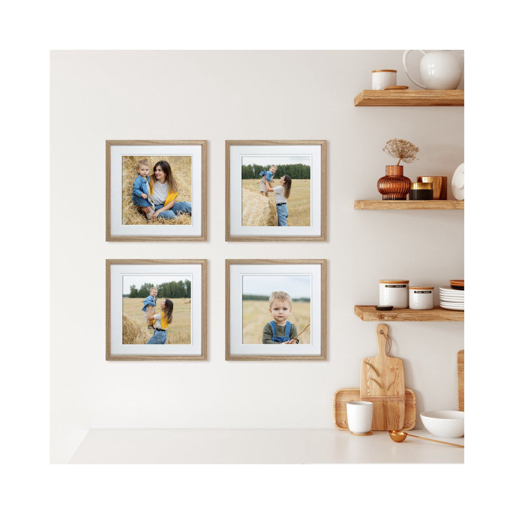 Four natural oak picture frames arranged in a 2x2 grid on a beige wall displaying family photos in outdoor settings.
