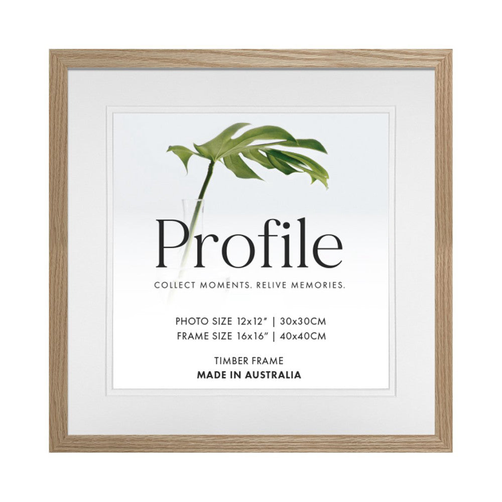 Front view of a natural oak timber picture frame with white matting, displaying product branding and specifications with a green leaf illustration.