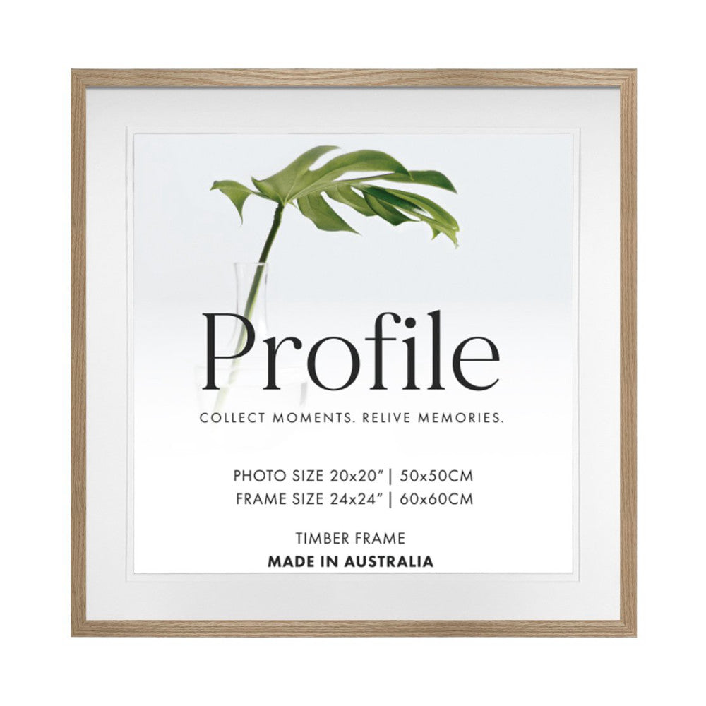 Front view of a timber picture frame with natural oak finish displaying sample text and a green plant stem in a glass vase.